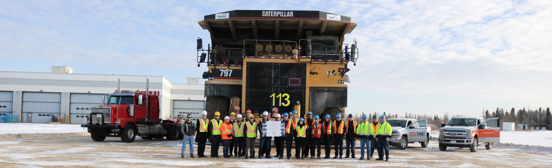 supporters standing in front of donated haul truck